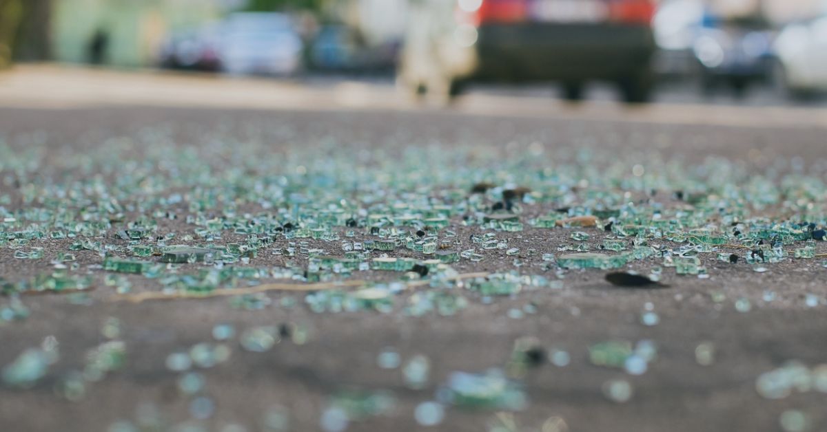 Broken glass scattered on road